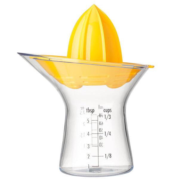 An OXO manual juicer with a yellow squeezer on top of a clear decanter.