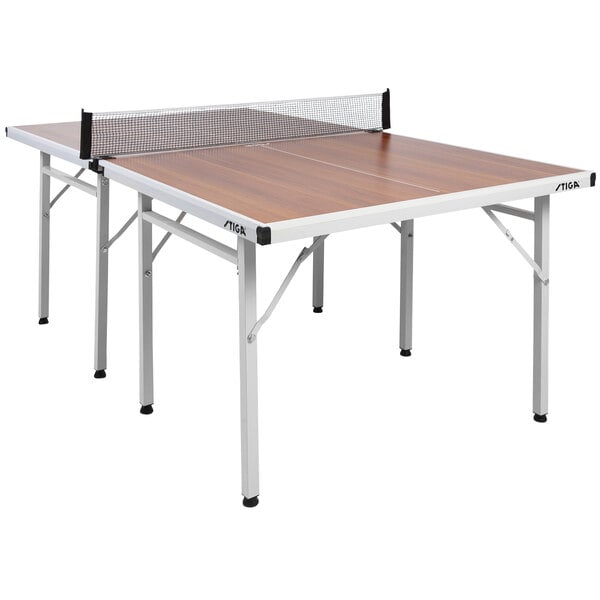 A Stiga ping pong table with woodgrain legs and a net.