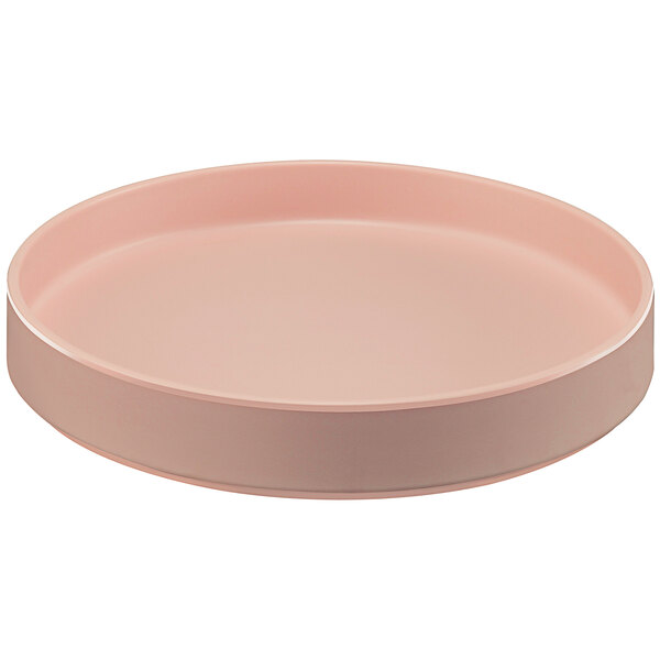 A Cal-Mil Hudson blush melamine plate with a raised rim on a table.