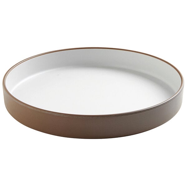 A white stoneware raised rim melamine plate with brown edges.