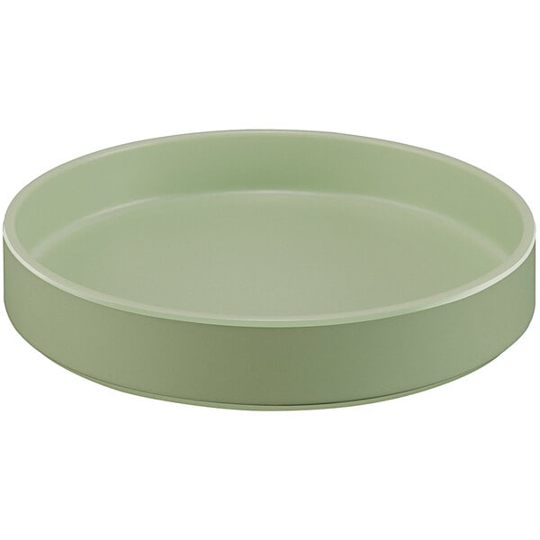 A round green melamine plate with a raised rim.