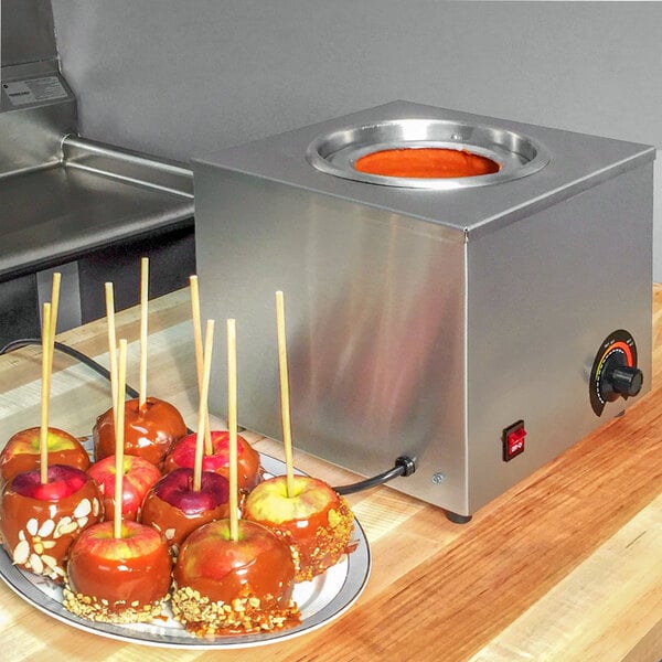 A Paragon caramel apple warmer with caramel apples on a plate.