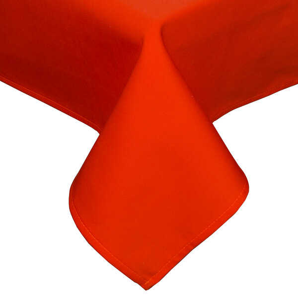 An orange Intedge rectangular tablecloth with a folded edge on a table.