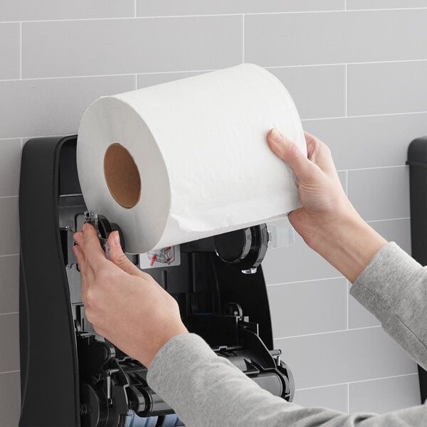 A person using a Lavex Select white paper towel roll.