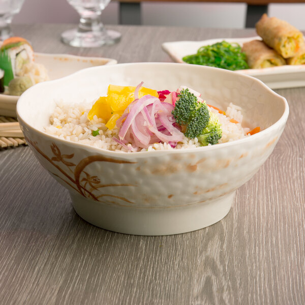 A bowl of rice with broccoli and other vegetables in a Thunder Group gold orchid melamine bowl.