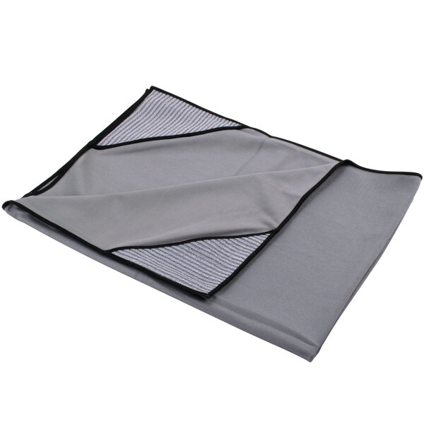 A grey microfiber cloth with black trim folded over.