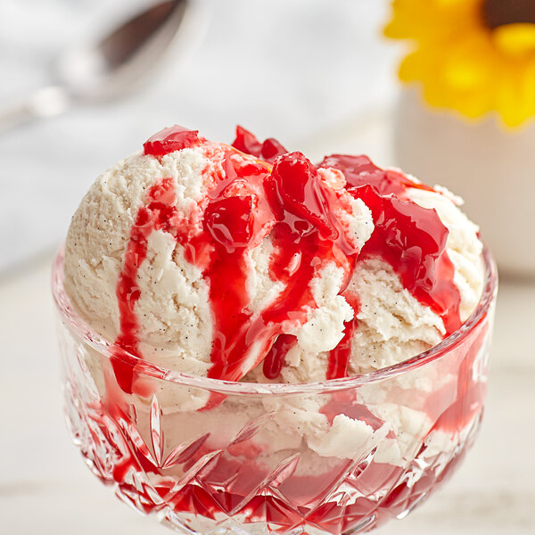 A bowl of ice cream topped with red J. Hungerford Smith cherry dessert topping.
