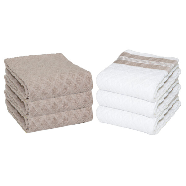 A stack of tan Monarch Brands Premier Collection terry kitchen towels with a diamond pattern on the edge.