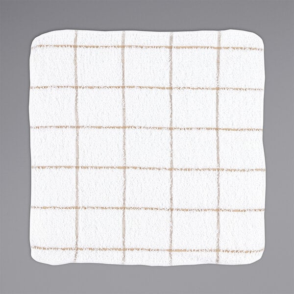 A tan dish cloth with a white and brown windowpane pattern.