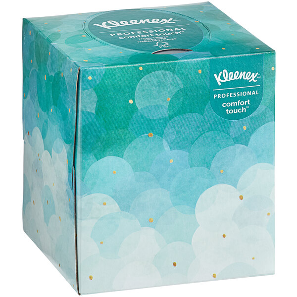 A Kleenex tissue box with blue and white clouds on the packaging.