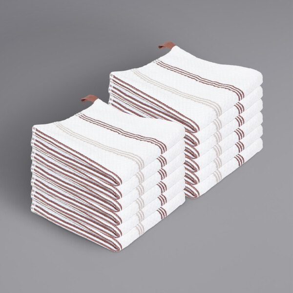 A stack of white towels with brown stripes.