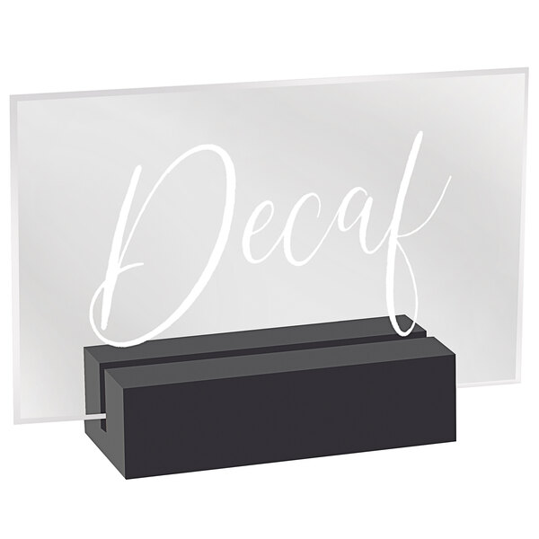 A clear acrylic sign with the word "Decaf" on a black wood base.