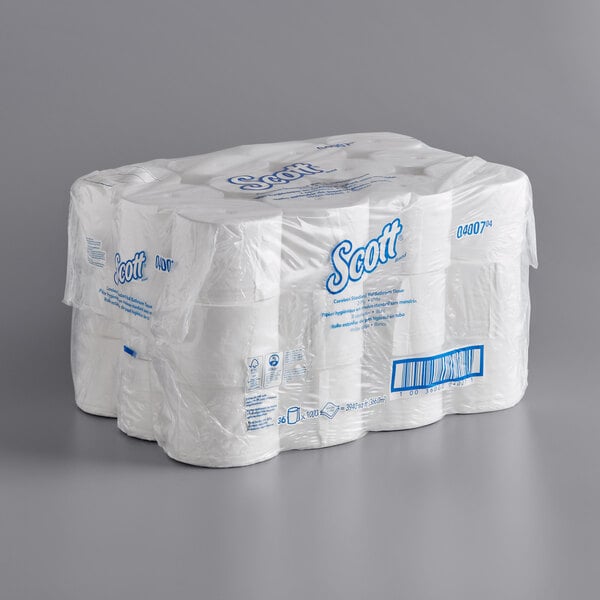 A large stack of Scott Essential toilet paper rolls.