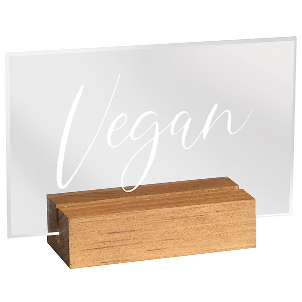 A wooden and clear acrylic Cal-Mil Madera "Vegan" sign on a wooden stand.