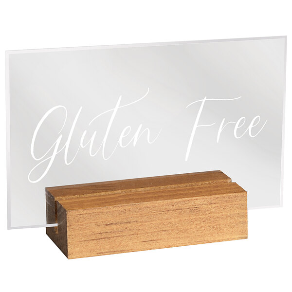 A clear glass "Gluten Free" sign in a wooden block stand.