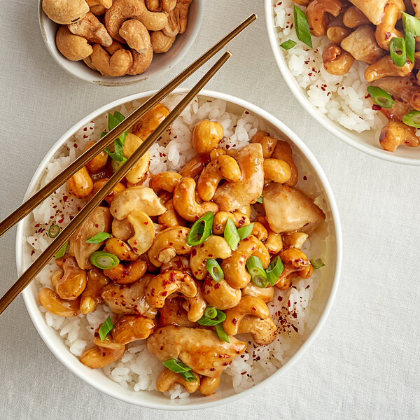 A bowl of rice with cashews.