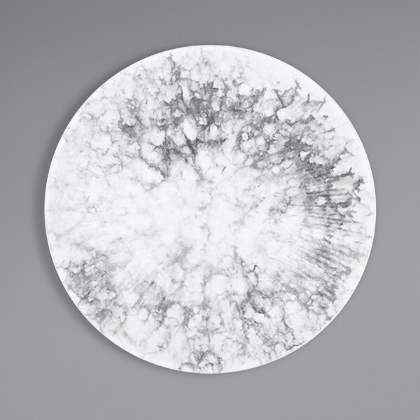 A white plate with black and white marble pattern on the surface.