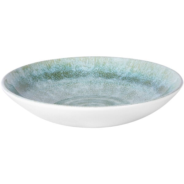 A white melamine bowl with a green and blue speckled surface.