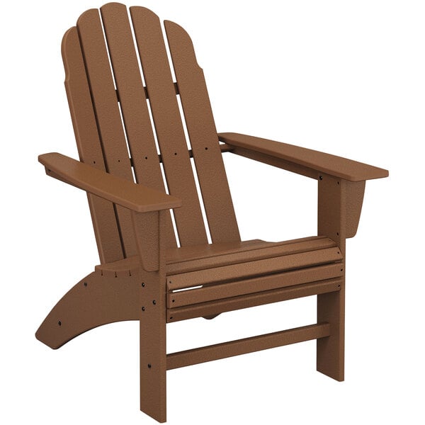 A brown POLYWOOD Vineyard Teak Adirondack chair with armrests.