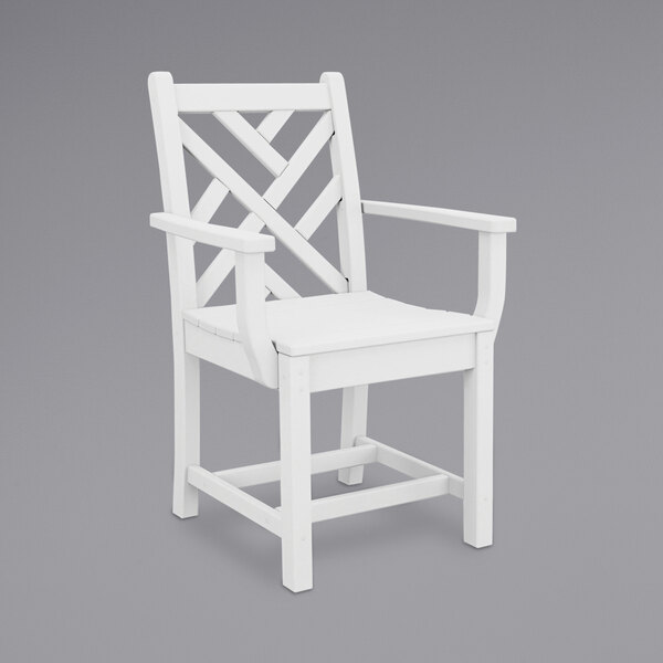 A white POLYWOOD Chippendale dining arm chair with a wooden frame.