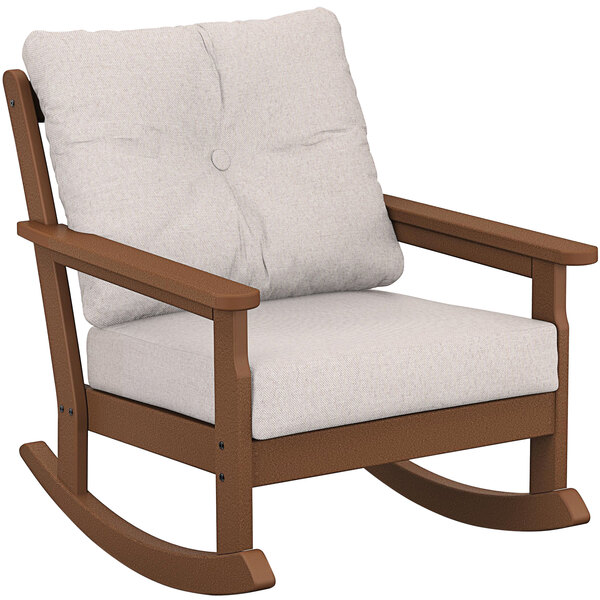A POLYWOOD Vineyard teak rocking chair with a white cushion.