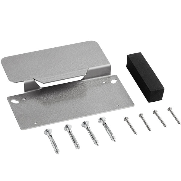 A Vitamix metal wall mounting bracket with screws and a black rubber pad.