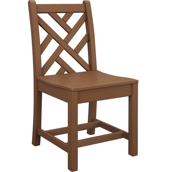 A brown POLYWOOD Chippendale teak dining side chair with a cross pattern on it.