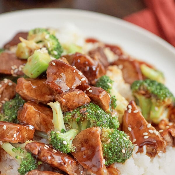 A plate of rice with meat and broccoli smothered in Lee Kum Kee Panda Brand Broccoli Beef Sauce.