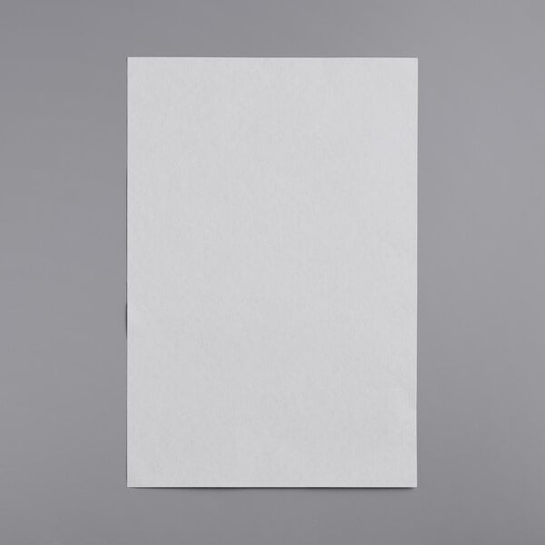 A white piece of paper on a gray surface.