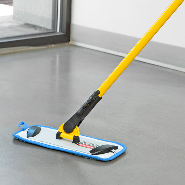 A Rubbermaid yellow and blue mop frame on a yellow handle.