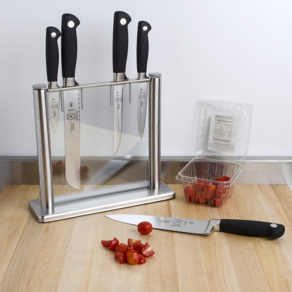 A Mercer Culinary Genesis knife set in a knife holder on a counter.