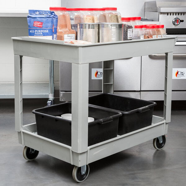 A Continental gray utility cart with food containers on it.