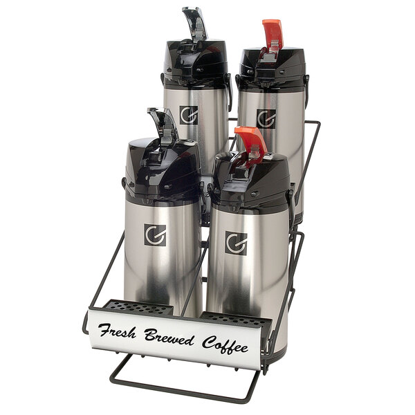 A Grindmaster wide airpot rack with two rows of two 2.2 liter glass lined lever action airpots on a counter.