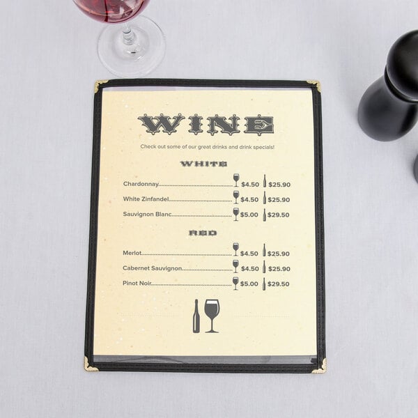 A 8 1/2" x 11" menu with a Southwest themed fiesta border on a table with a glass of wine.