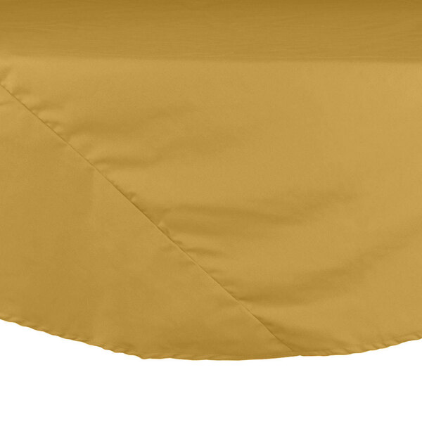A close-up of a round yellow Intedge cloth table cover on a table.