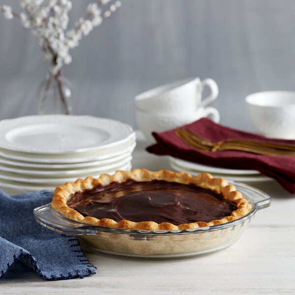A pie in an Anchor Hocking glass pie dish on a table.