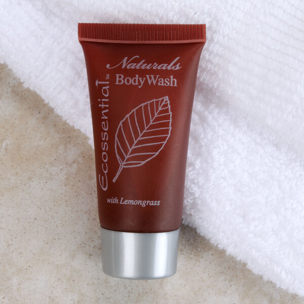 A small white tube of Ecossential Naturals body wash with a white leaf on the label.