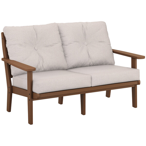 A POLYWOOD teak loveseat with brown armrests and white cushions.