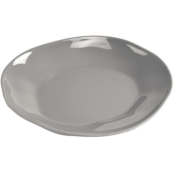 A gray Cal-Mil ash melamine plate with a curved edge.