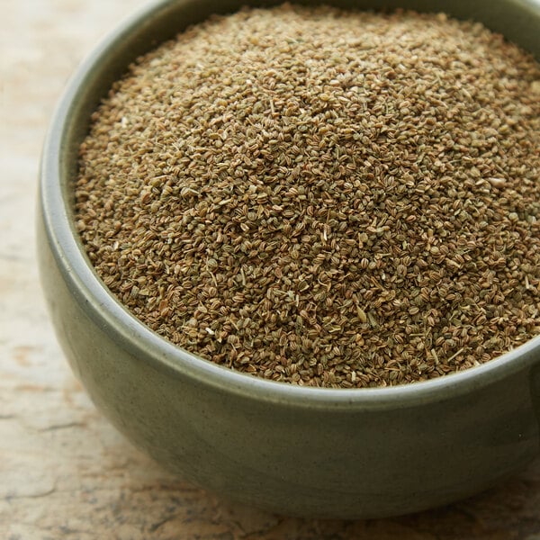 A bowl of Regal celery seed powder on a wooden table.