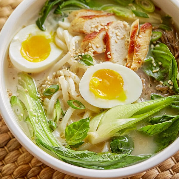 A bowl of Japanese-style pork bone soup with meat and eggs.