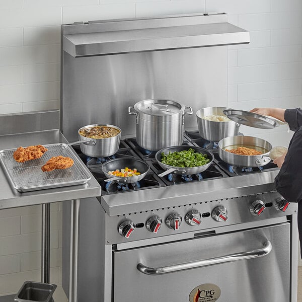 A woman cooking with Choice aluminum cookware on a gas stove.
