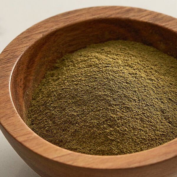 A bowl of Regal Ground Thyme powder on a table.