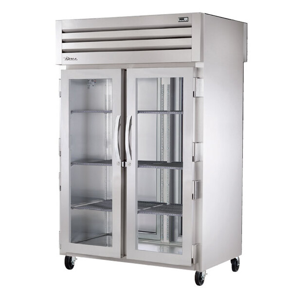 A True Spec Series pass-through heated holding cabinet with glass front and solid back doors.