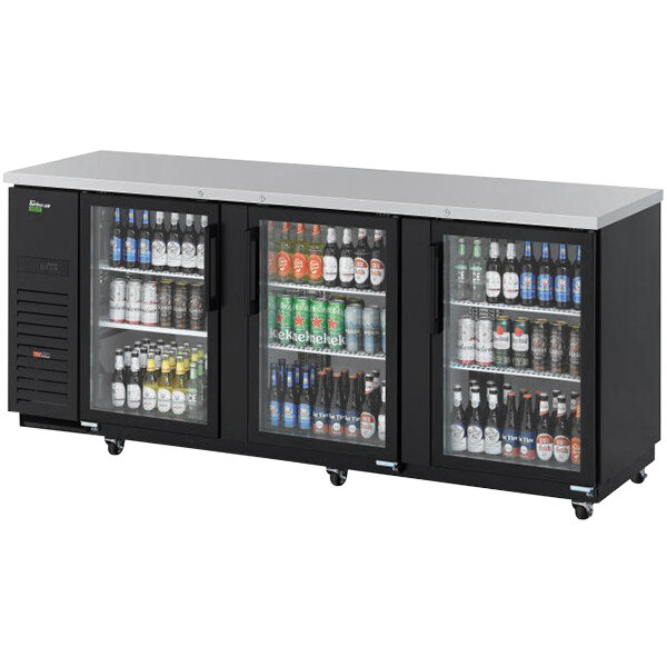 A black Turbo Air Super Deluxe back bar cooler with glass doors full of beverages.