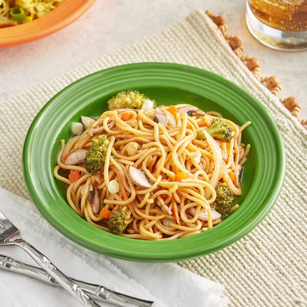 An Acopa Capri palm green stoneware plate with noodles and broccoli on it.