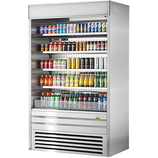 A Turbo Air stainless steel vertical air curtain display case full of beverages.