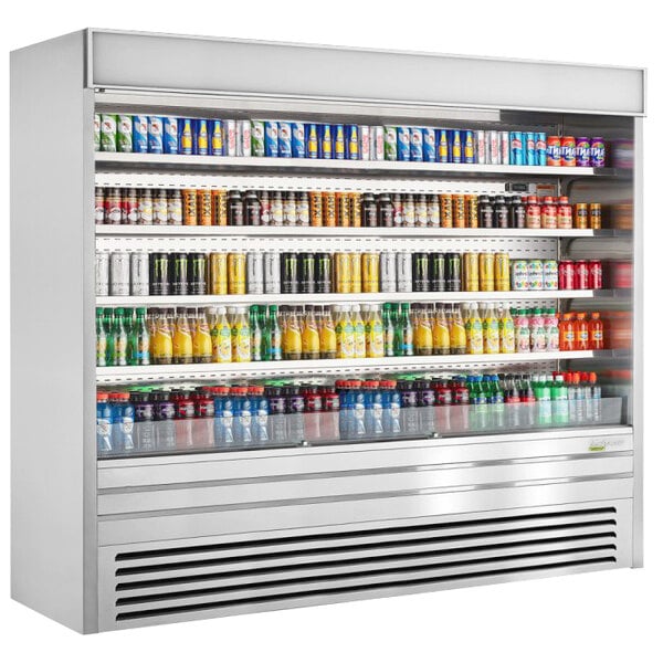 A white Turbo Air vertical air curtain display case filled with drinks on shelves.
