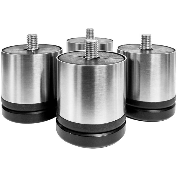 Four stainless steel adjustable legs for an Ice-O-Matic ice machine on a table.