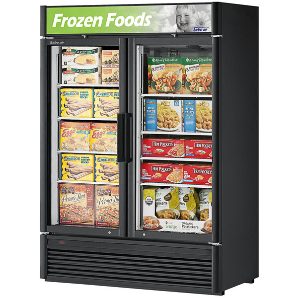 A Turbo Air Super Deluxe swing door freezer with frozen food inside.